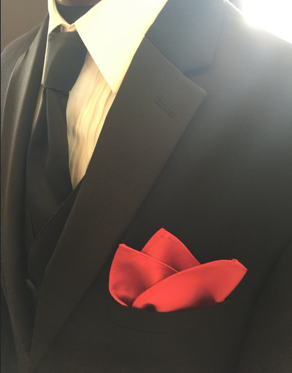 Long black tie and a red pocket square