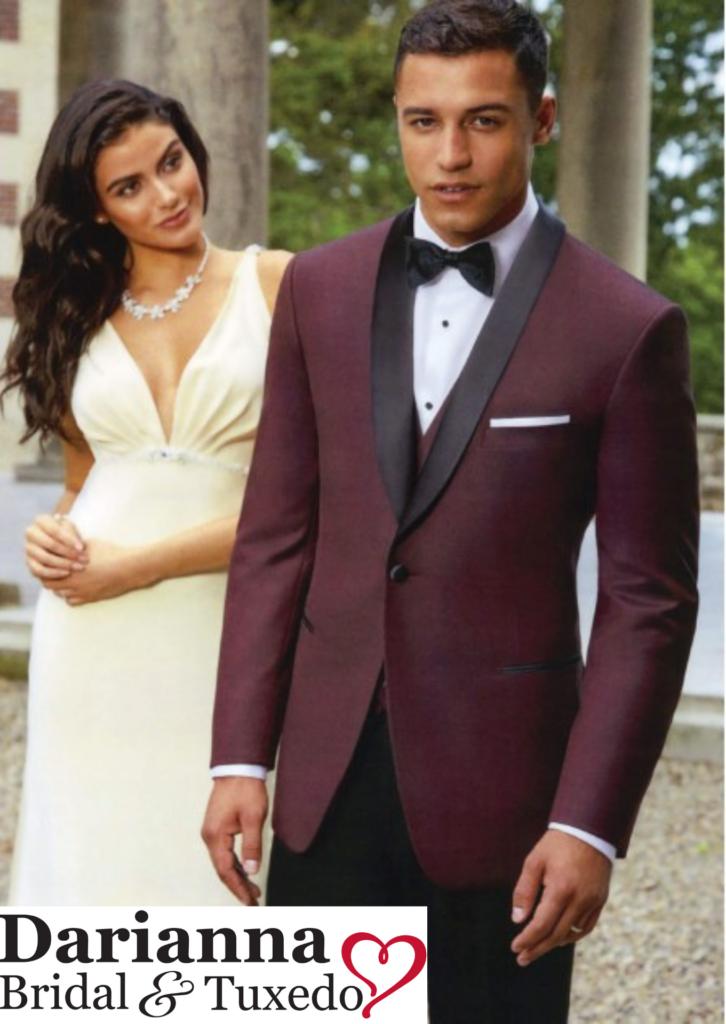 Model in burgundy colored tuxedo with black satin shawl lapel and black pants