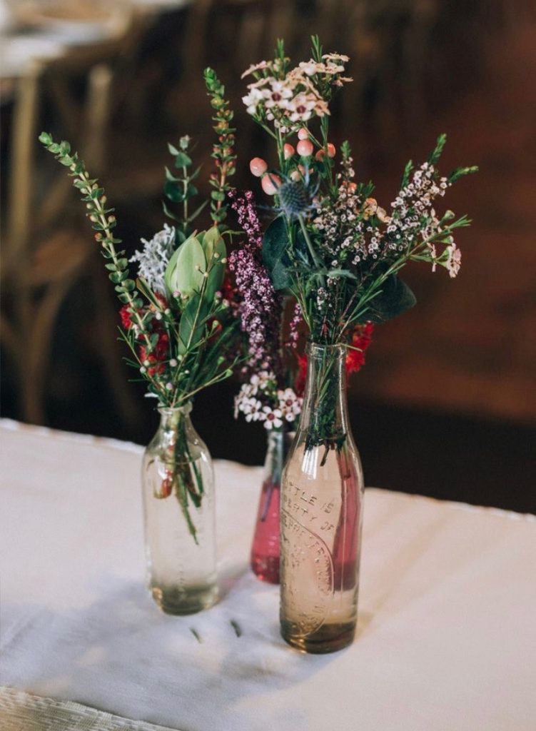 wildflowers in vintage colored glass bottles 